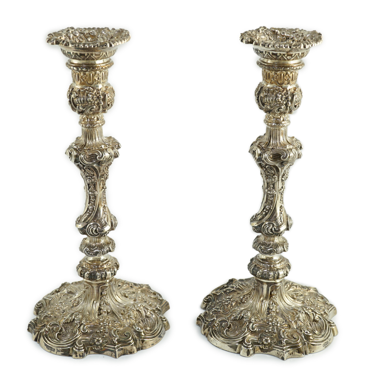 An ornate pair of Edwardian silver candlesticks, by Walker & Hall